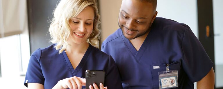 Two professionals discussing on smartphone.