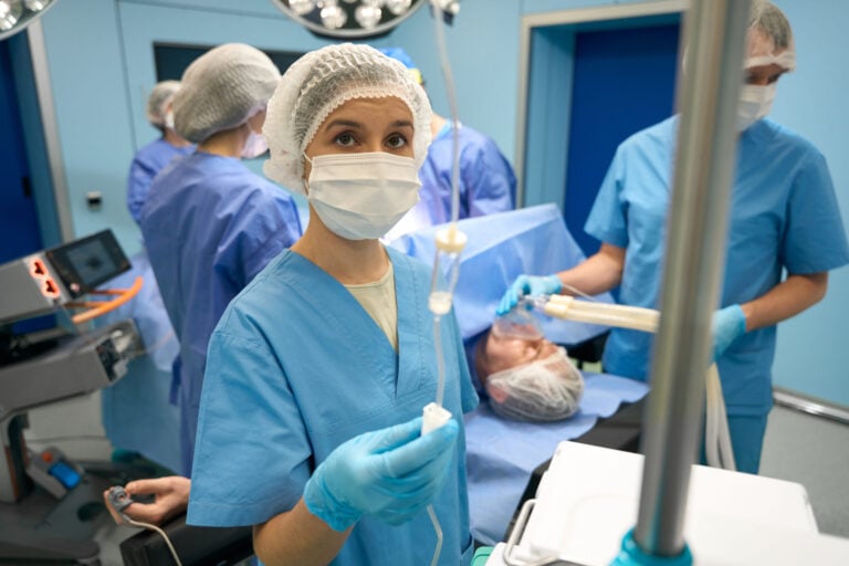 Surgical team in operating room setting.