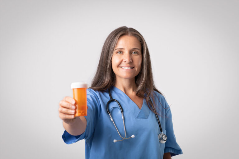 Doctor holding a prescription bottle.