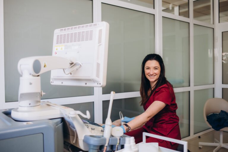 Medical professional operating ultrasound machine.
