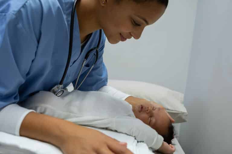 Doctor examining baby in clinic.