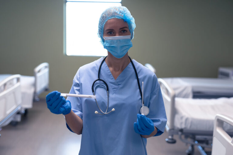 Doctor holding medical instruments in hospital.