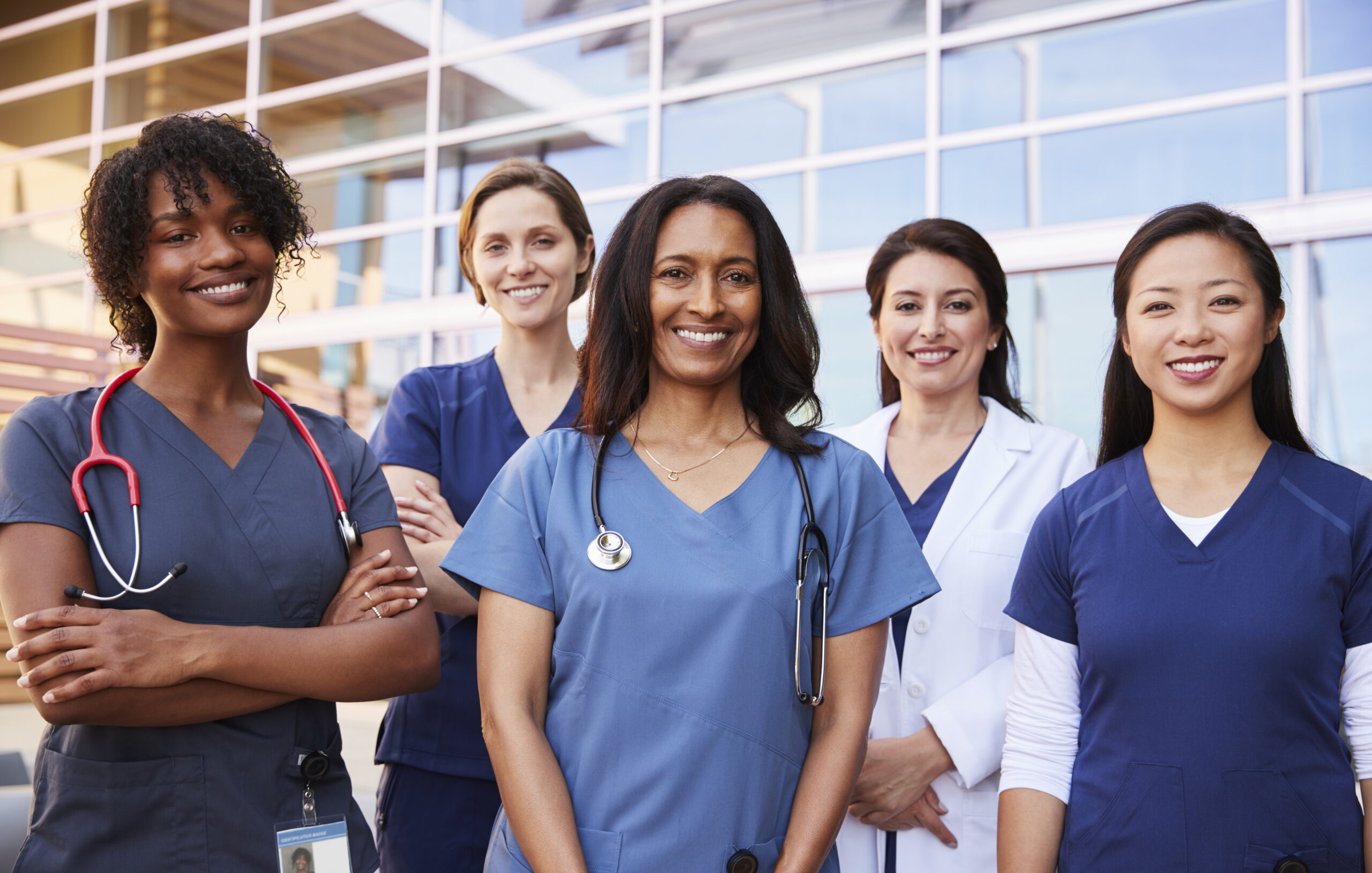 International Women’s Day 2025: Accelerate Action for Gender Equality 1 Female healthcare colleagues standing outside hospital