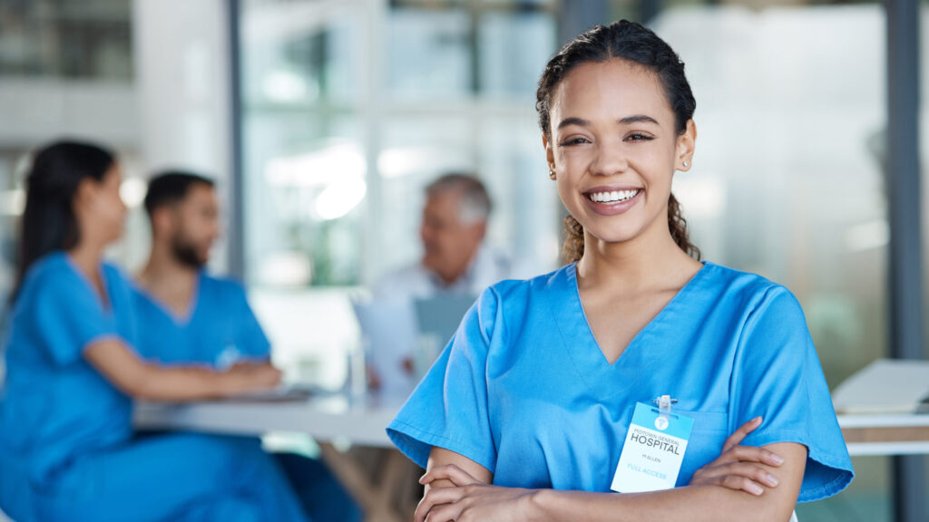 A picture of smiling young nurse with arms folded.