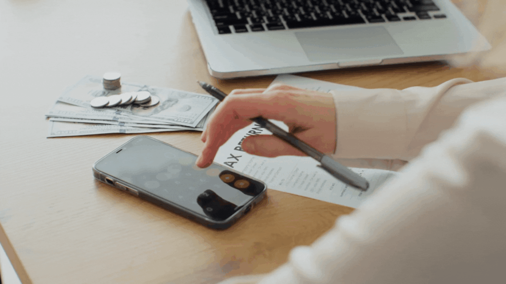 Person managing finances with smartphone