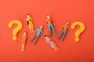Colorful figurines with question marks.