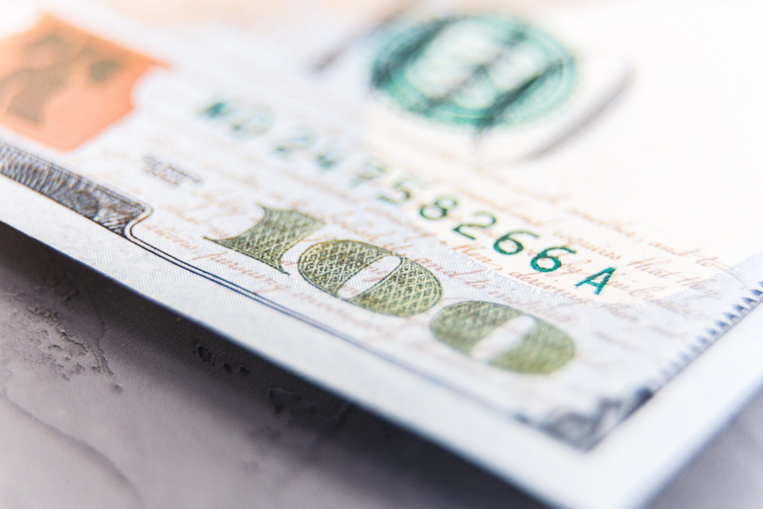 Scrubs & Cents: Five Core Pillars of Financial Wellness for Healthcare Professionals 3 Close-up of a hundred dollar bill