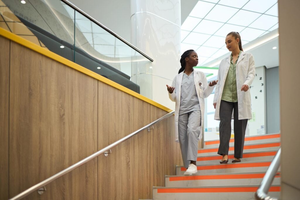 Two medical professionals walking together.